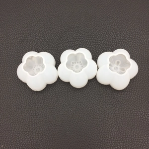 Three translucent cherry blossom silicone molds with detailed floral patterns for DIY resin