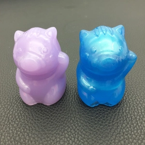 Macro detail of pearlescent purple and blue 3D pig resin molds with glitter finish