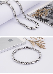 Detailed view of two-tone twist chain necklace and bracelet with lobster clasp