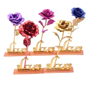 Five assorted gold foil artificial roses in purple, red, pink, gold and blue with Love base