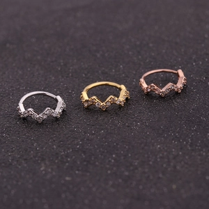 Micro-set zircon wavy nose studs in silver, gold, and rose gold on black texture
