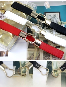 Detailed view showing gold buckle and elastic bands in black white and red colors