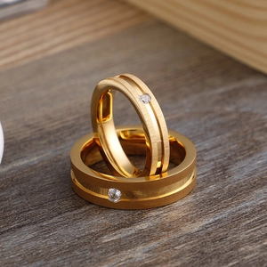 Brushed gold stainless steel couple rings with sparkling center cubic zirconia stone
