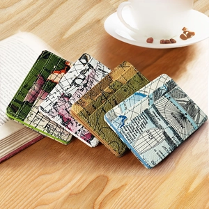 Macro view of four colorful PU leather camo magic wallets with vintage map patterns on wood