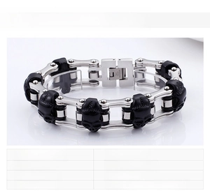 Macro detail of men's chunky stainless steel skull bracelet with 134g weight mark