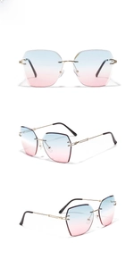 Detail view of rimless sunglasses with blue-pink gradient lenses and gold metal temples