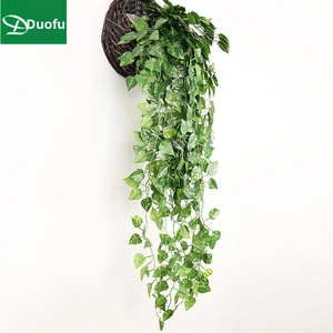 Artificial hanging pothos plant in dark brown wicker basket for wall decor