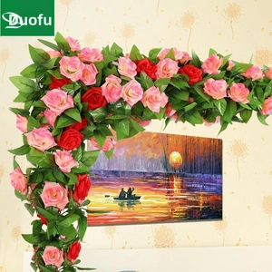 L-shaped wall decoration featuring pink and red artificial rose vines with green leaves