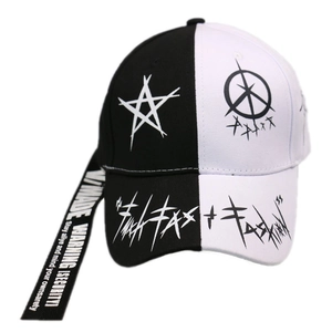 Detail of split black and white baseball cap with graffiti stars and long slogan straps