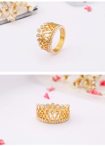 Detail view showing golden crown ring with white crystals and elegant sparkling finish