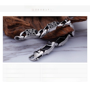 Macro view of stainless steel men's bracelet with skull and cross relief details