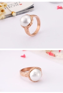 Macro view of shell pearl on rose gold titanium steel ring with unique textured band