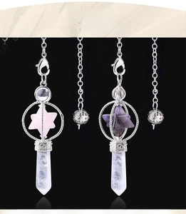 Detailed view of rotating Merkaba star crystal pendants in rose quartz and amethyst stones