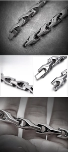 Detailed macro view of polished silver tungsten steel links and secure clasp on men's bracelet