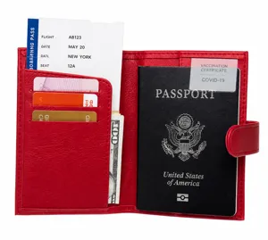 Detail view of red pebbled leather passport holder with multi-card slots and snap closure
