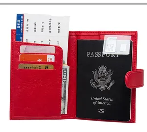 Detail view of red pebbled leather passport holder with multi-card slots and snap closure