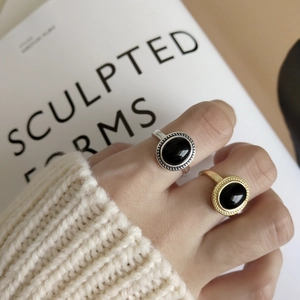 Detail of minimalist 925 silver ring with black onyx and vintage beaded edge on hand