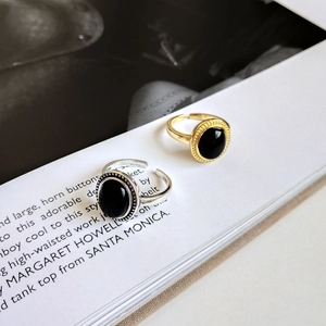 Close-up of S925 sterling silver ring with black agate stone on fashion magazine