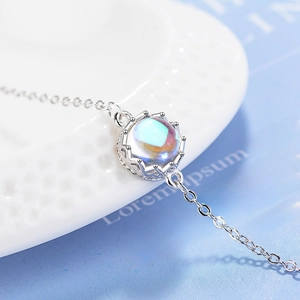 Elegant silver crown bracelet featuring a round iridescent moonstone on a delicate chain