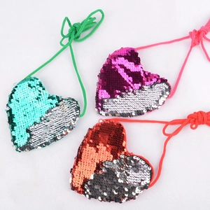 Mini heart-shaped sequin crossbody bags in mint green, purple, and orange for kids