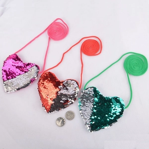 Detail of reversible sequin heart mini purses in pink, orange and green colors