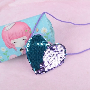 Macro shot of heart-shaped flip sequin kids purse showing blue and purple gradient details