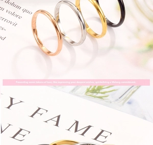 Macro view of polished minimalist rings in rose gold, silver, gold, and black finishes