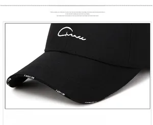 Close-up of black baseball cap brim featuring FASHION ribbon and detailed stitching