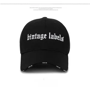 Close-up of black baseball cap with white bintage labels embroidery and fashion lettering