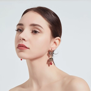 Detailed shot of ethnic style drop earrings with colorful gems and red crystal pendant