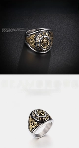 Close-up of golden USN anchor and eagle engraving on vintage stainless steel ring