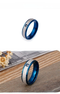 Detail view of titanium steel ring featuring blue frosted finish and single zircon inlay