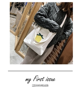 Detail of white canvas tote bag featuring a cute yellow pineapple patchwork embroidery