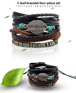 Macro detail of leaf charm bracelet set featuring woven leather and wooden beads