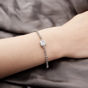 Detail shot of heart-shaped crystal bracelet with round zircon stones on wrist