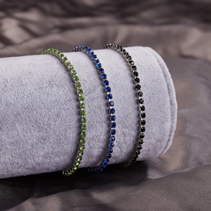 Detailed view of three sparkling zircon tennis bracelets with heart pendants on velvet display
