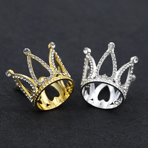 Detailed view of silver and golden crystal mini crowns for birthday cake decoration