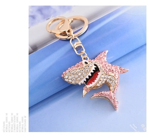 Detail of pink rhinestone shark keychain with golden alloy ring and lobster clasp