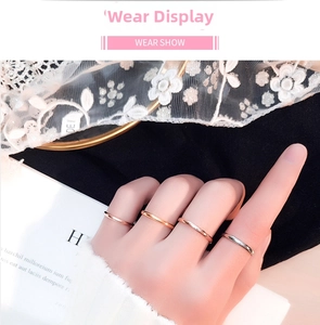 Minimalist stackable titanium steel rings in rose gold and silver shown on fingers