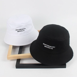 Classic black and white cotton bucket hats with Brooklyn embroidery in a 45-degree view