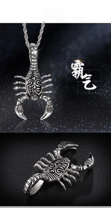 Macro view of a stainless steel scorpion pendant with intricate floral engravings