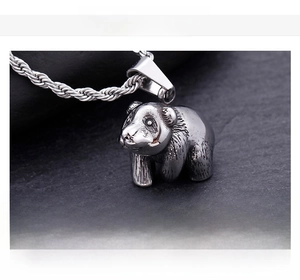 Detail view of a vintage stainless steel panda pendant with realistic texture and rope chain