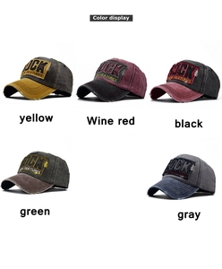 Close-up of vintage washed cotton baseball caps with ROCK embroidery and distressed edges