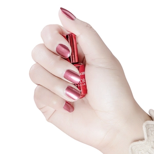 Macro shot of metallic red nail polish with a glossy mirror finish on nails
