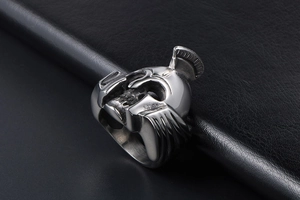 Macro detail of Spartan skull helmet ring made of polished silver titanium steel