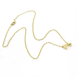 Golden stainless steel heart pendant necklace with S letter charm on white backdrop