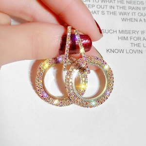 Macro shot of double circle gold earrings featuring shimmering multi-colored pavé rhinestones