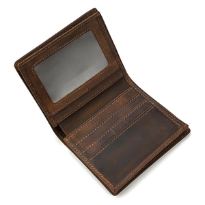 Detail view of genuine leather bifold wallet featuring multiple card slots and ID window