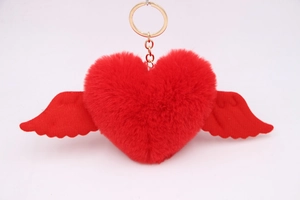 Detail view of the red plush heart keychain with soft wings and gold metal ring