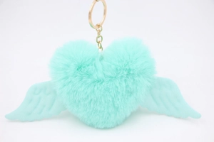 Close-up of mint green heart plush keychain with soft wings and golden metal buckle